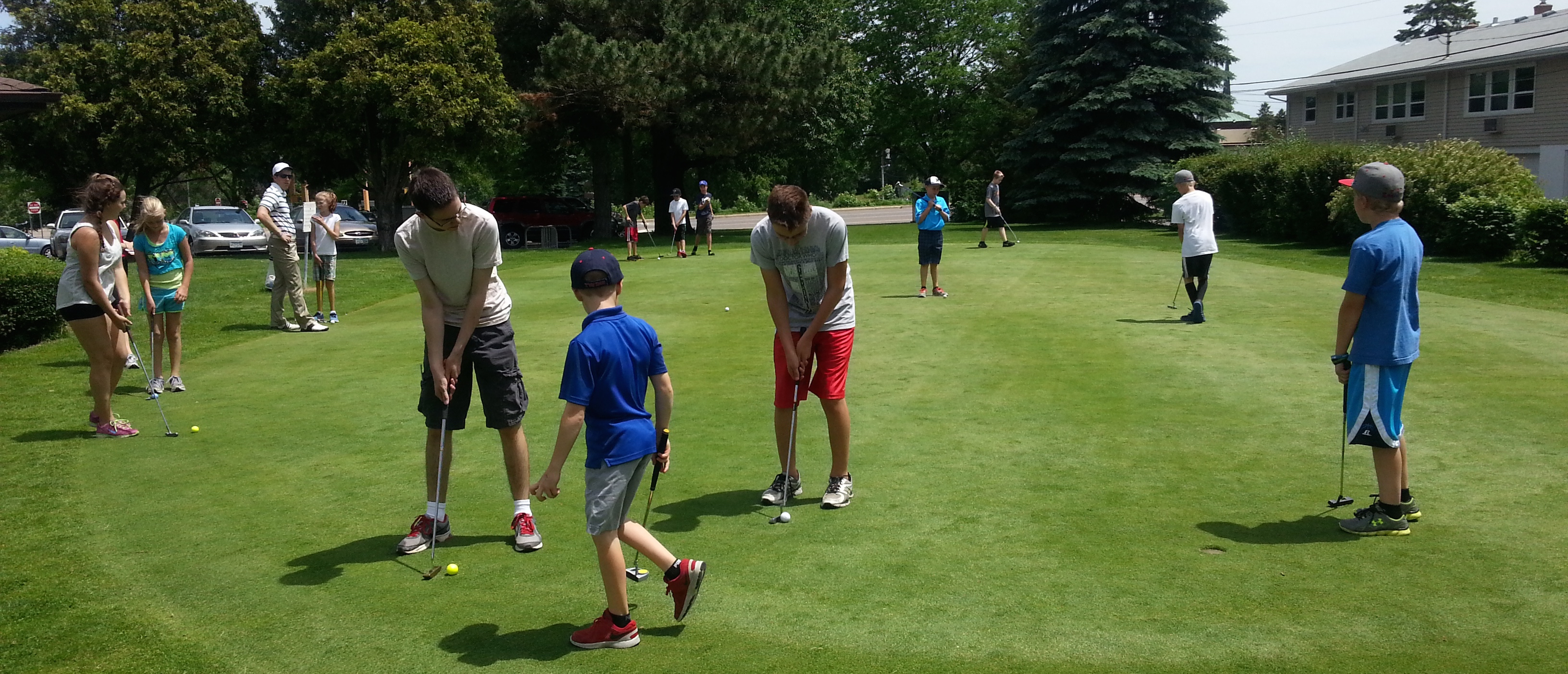 Young golfers on putting green