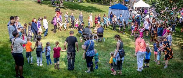 large circle of people dancing around drummers