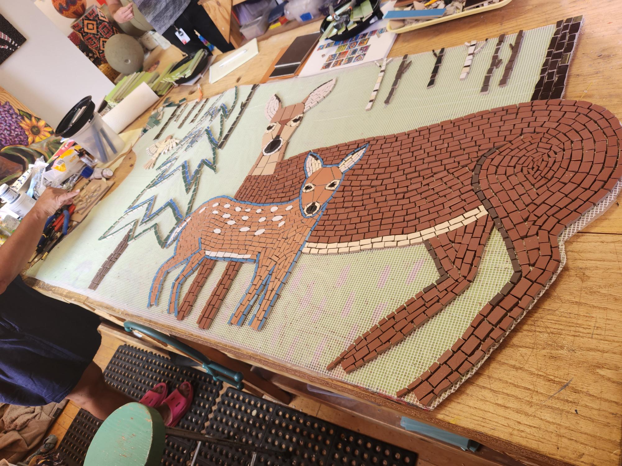 Mosaic artist Lori Greene works on her newest installation for Harriet Alexander Nature Center.