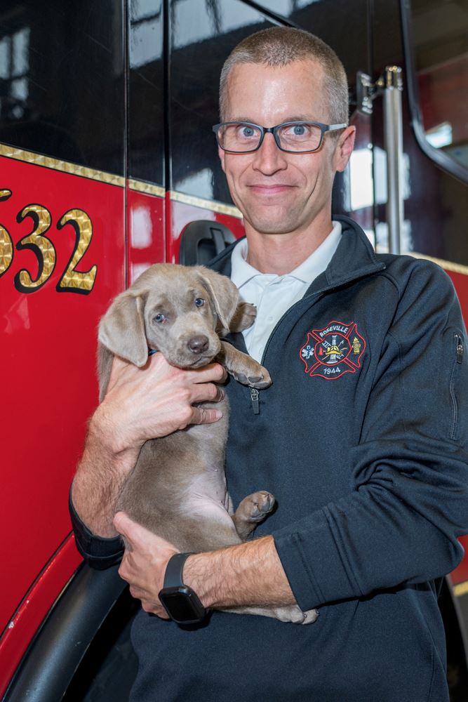 Ashes with her handler, Assistant Chief Neil Sjostrom.