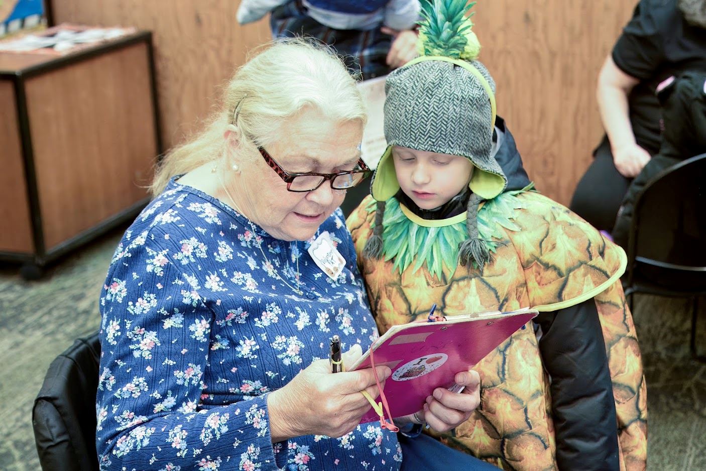 Volunteer Pat Waletzko helps youngsters at Harriet Alexander Nature Center.