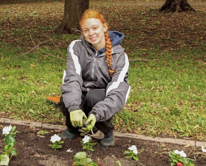 Volunteers Sophie and Olivia Martin plant flowers at Blooming Boulevard event at Central Park.